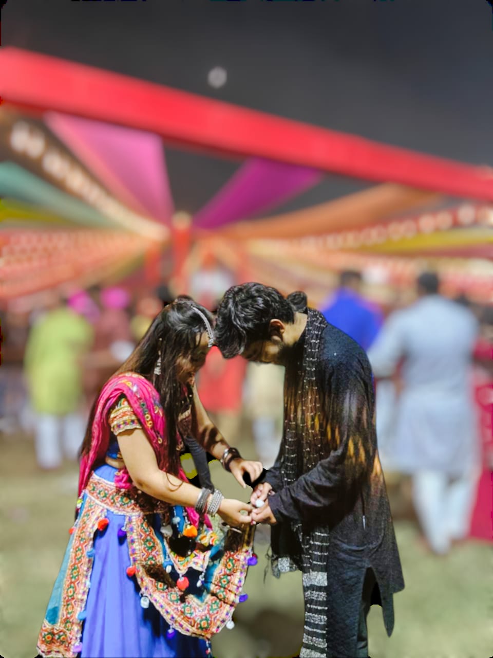 The two of us standing close in colourful traditional clothes.